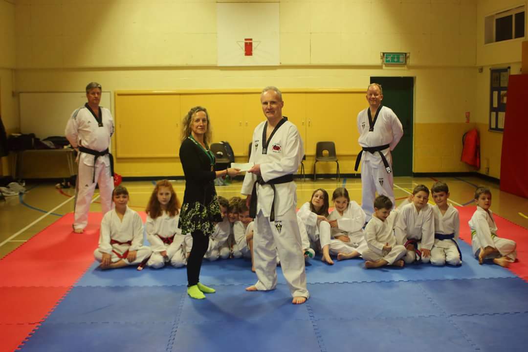 Ms Alison Peters, chair of Alveston Parish Council, with members of Frontline Martial Arts